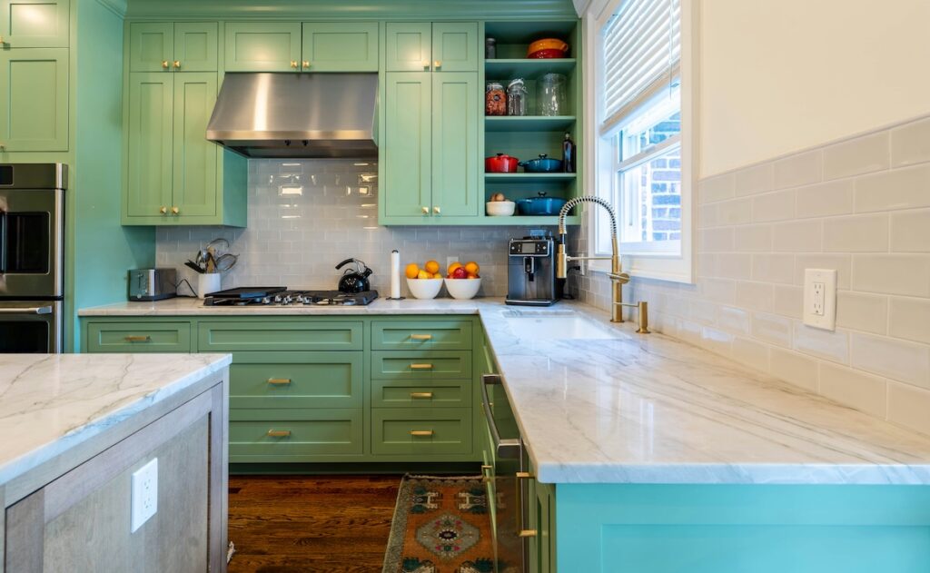 kitchen with green cabinets and white vinyl window